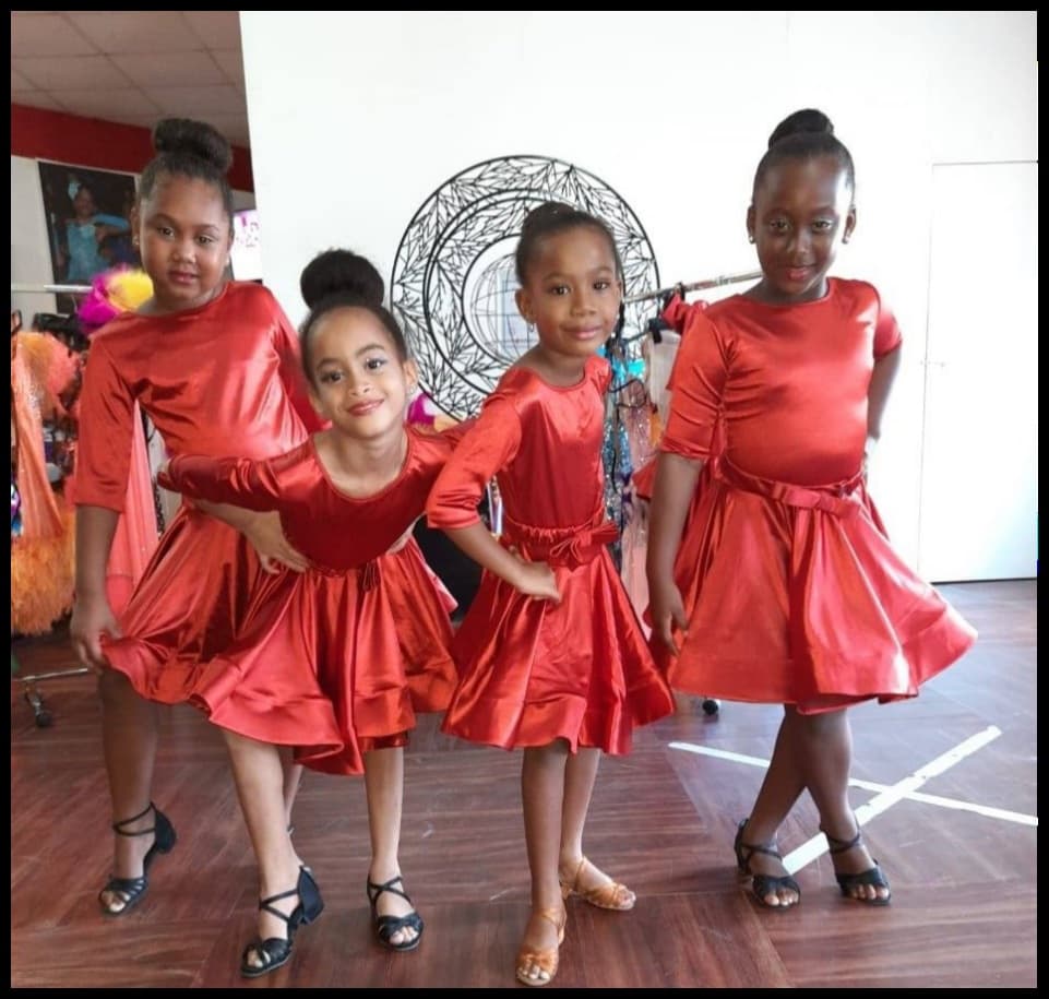 Young Heartbeat dancers in red performance dresses